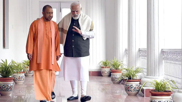 Opposition reacts to UP CM Yogi Adityanath's pic with PM Modi - India News